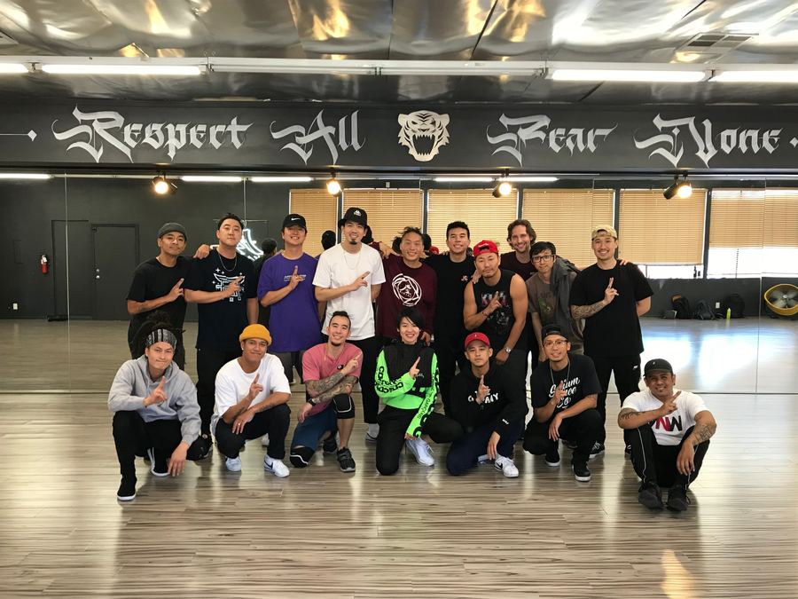 The crew inside the Monterey Park Dojo, Respect All Fear None painted on the wall