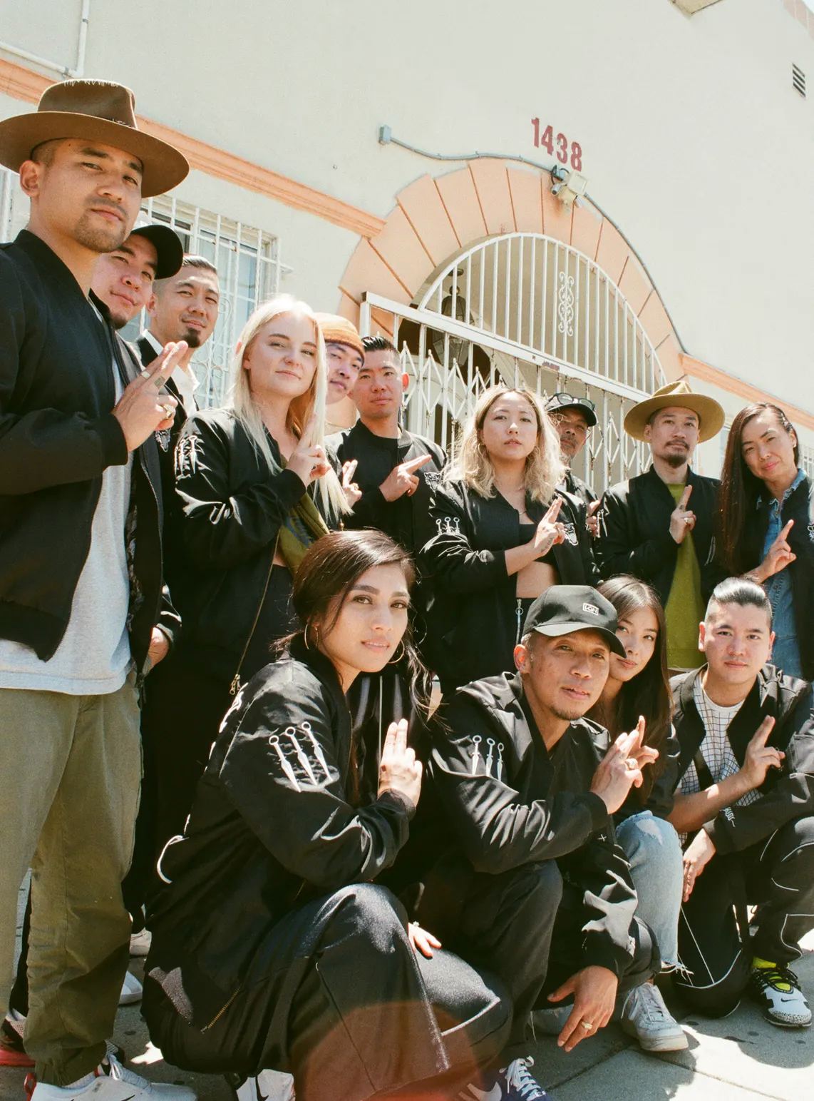 The crew in matching black jackets, posed outside